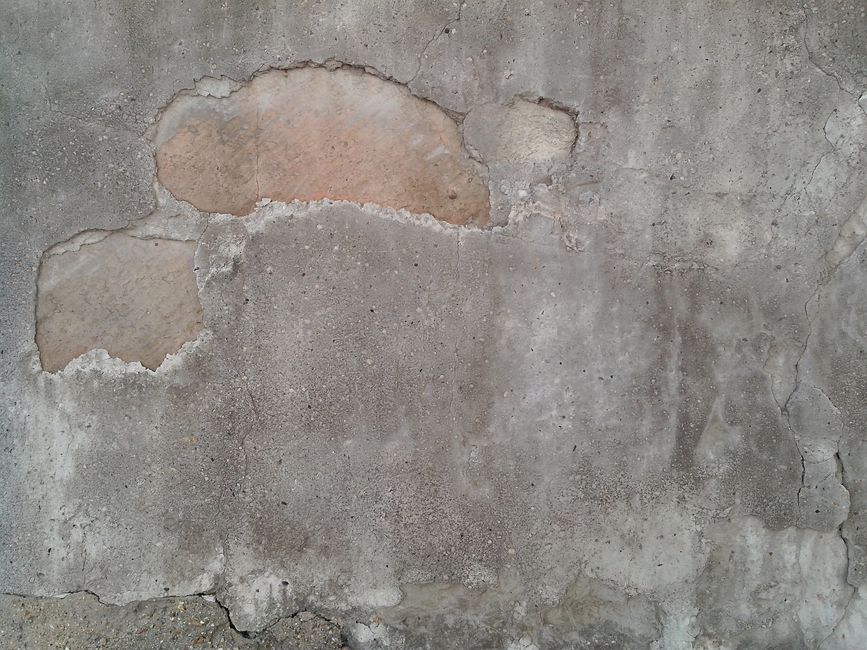Close-up of a weathered wall with exposed patches.